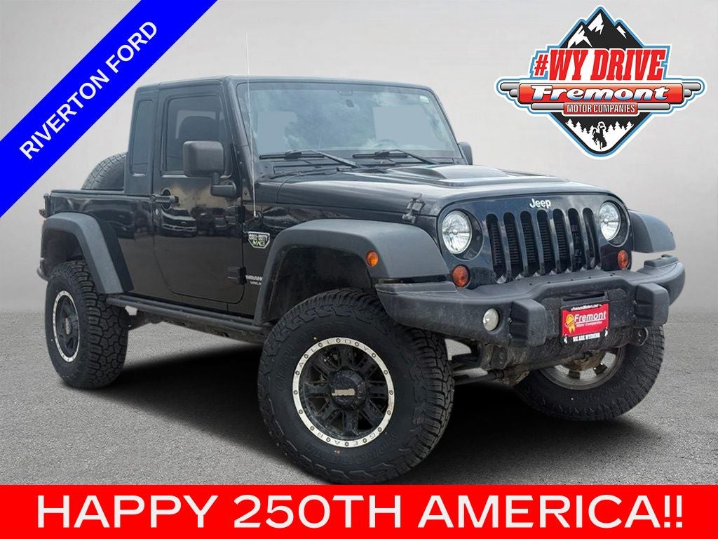 2012 Jeep Wrangler Unlimited Rubicon in Black Clearcoat — front three-quarter view
